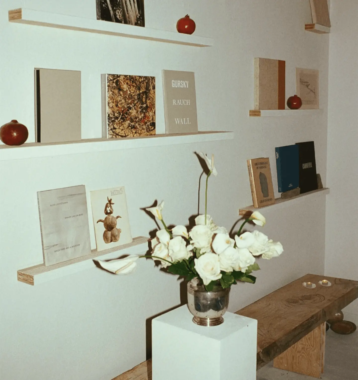 Books, pomegranates and white roses on shelves in the Monastery spa