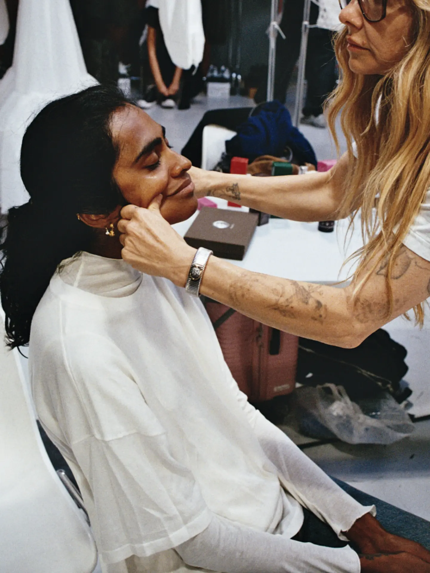 A Monastery esthetician in white giving a facial massage to a client